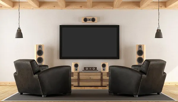 Modern home theater installation featuring flat screen TV and comfortable seating, highlighting benefits of professional setup.