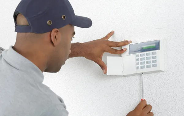 Technician Installing a Burglar Alarm System - Best Security Solutions in Palm Beach Island